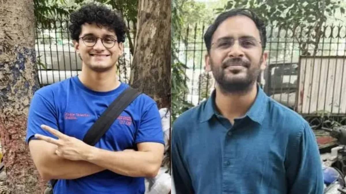 दो आदमी बाहर खड़े हैं, एक नीली टी-शर्ट और दूसरा नीली शर्ट पहने हुए।